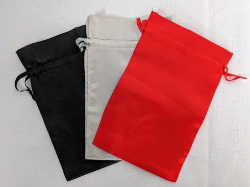 satin gift bags in black, silver, and red